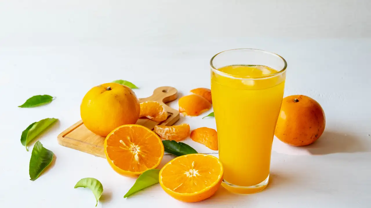 Real Orange Juice: The B2B Profit Driver 1 Fresh oranges being squeezed for real orange juice